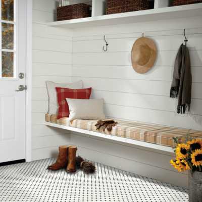 black and white penny tile in entryway with white shiplap walls and earth toned colors